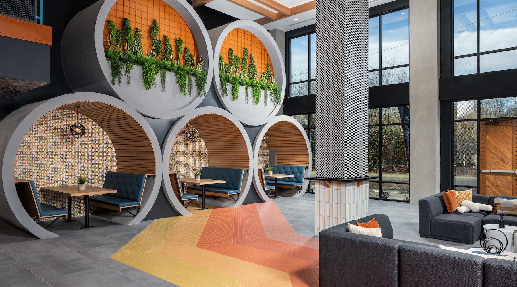 The resident lounge at Broadstone Craft Apartments in Charlotte, NC, featuring booth seating and modern decor.