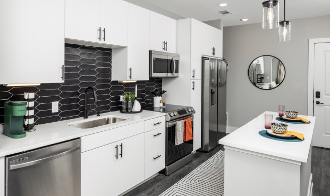 Model kitchen at Broadstone Craft apartments for rent in Charlotte, NC, featuring stainless steel appliances.
