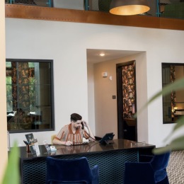 a man at a desk while on the phone