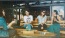 People sitting at an outdoor dining area at a bar near Broadstone Craft apartments for rent in Charlotte, NC.